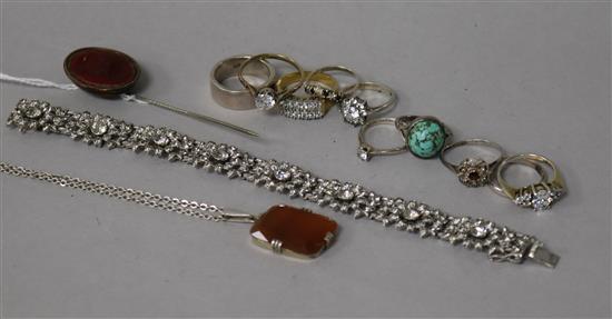 Ten assorted silver dress rings, a pendant, intaglio stick pin and a silver bracelet.